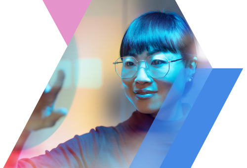 Alt text: A woman with glasses interacts with a digital interface, showcasing innovation and technology in a vibrant setting.