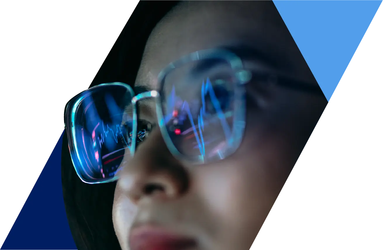 Person with glasses reflecting digital graphs, technology theme.